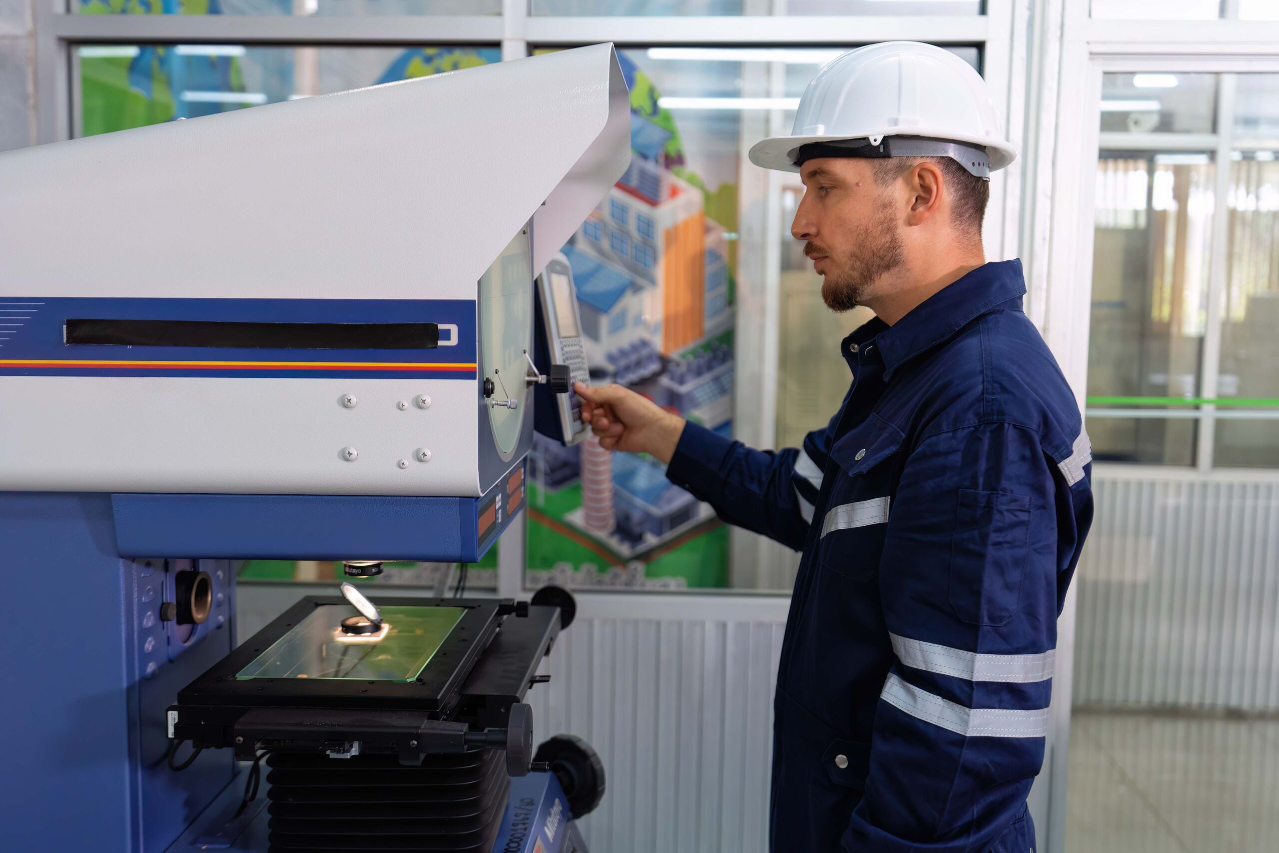 An engineer using optical micrometer quality checking micro part