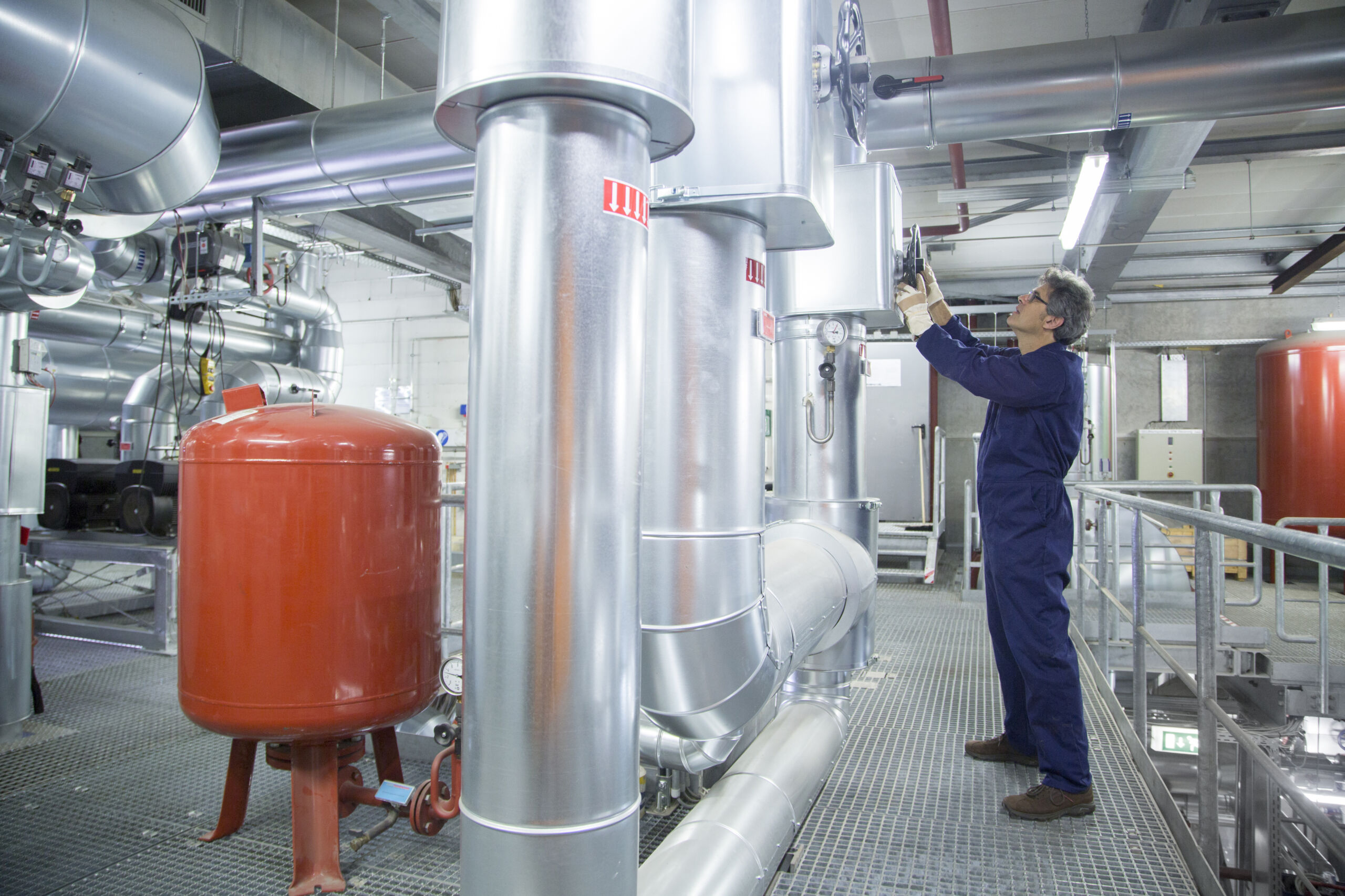 Engineer adjusting equipment in power station